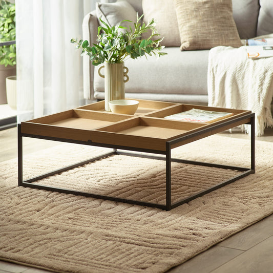 Square coffee table with four compartments in a living room setting