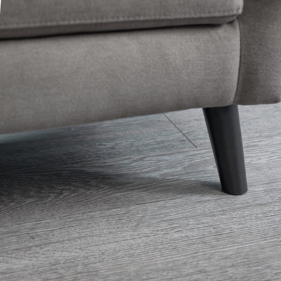 Gray sofa leg on a wooden floor