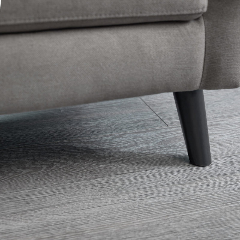 Gray sofa leg on a wooden floor