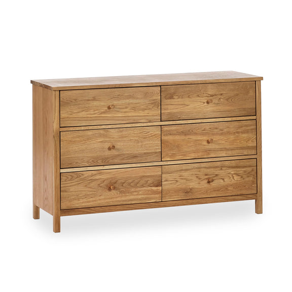 Wooden dresser with four drawers on a white background