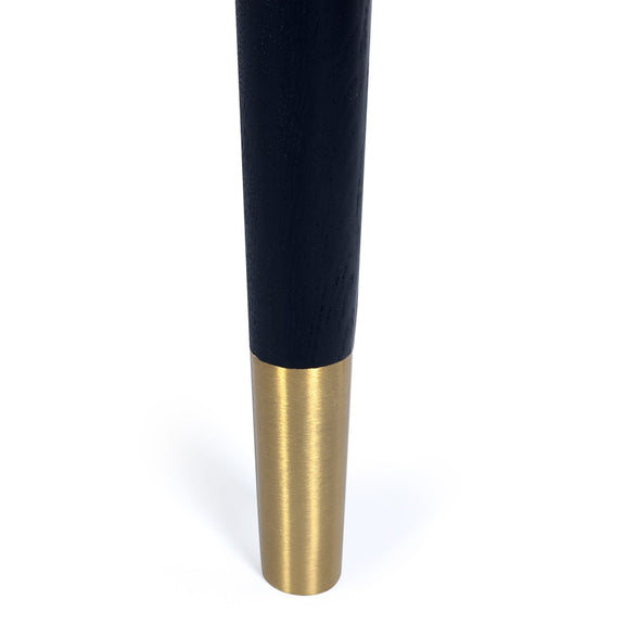 Black and gold cylindrical object on a white background