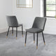 Two gray chairs with black legs on a gray floor.