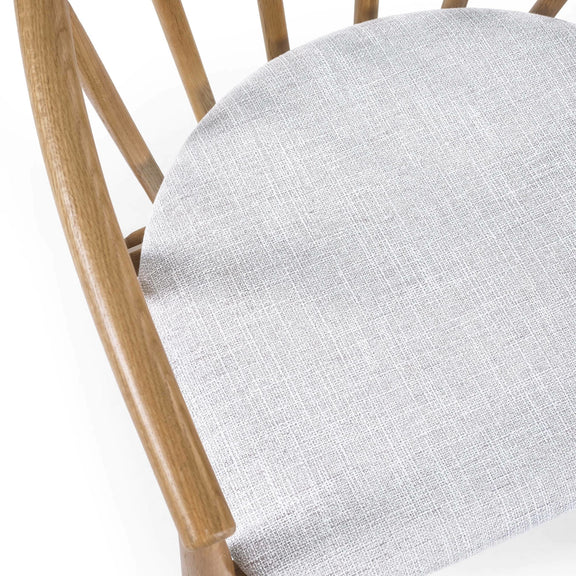 Close-up of a chair with a wooden frame and gray cushion on a white background