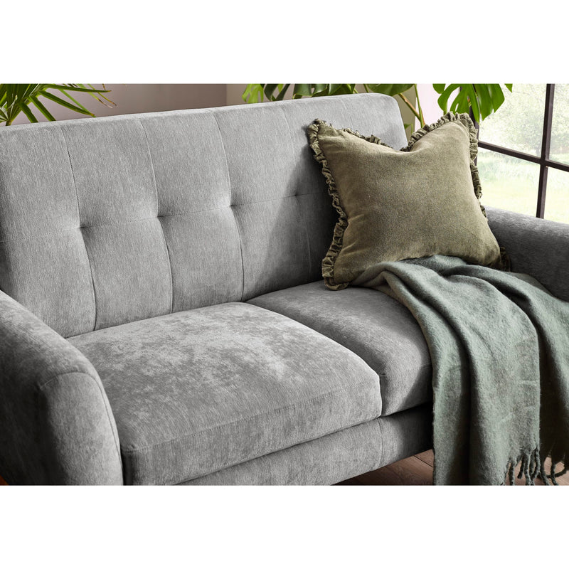 Gray sofa with a green pillow and blanket in a room with plants.