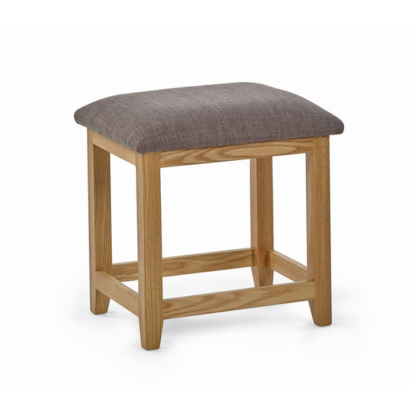 Wooden stool with a gray cushioned seat on a white background