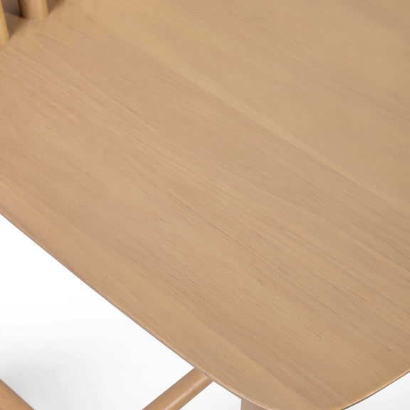 Close-up of a wooden chair with a light brown finish on a white background