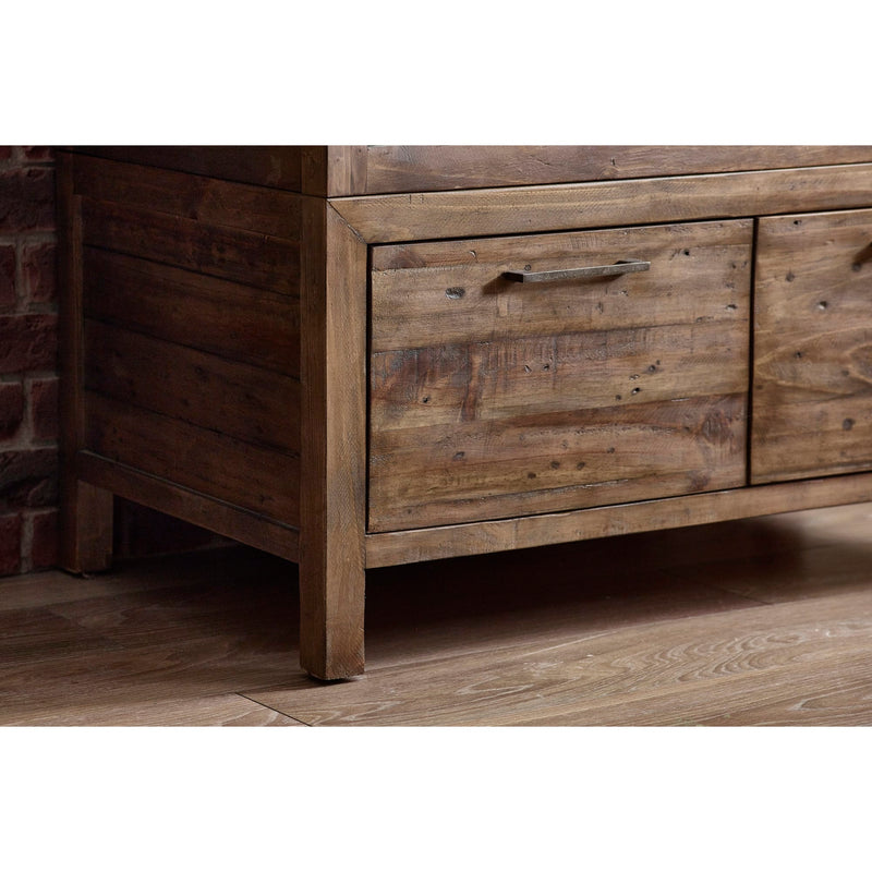 Wooden dresser with drawers against a brick wall.
