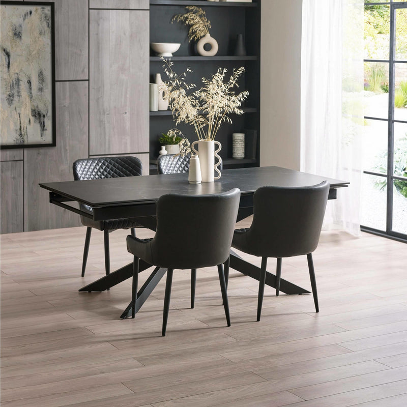 Dining room with a black dining table and chairs in a modern interior setting.