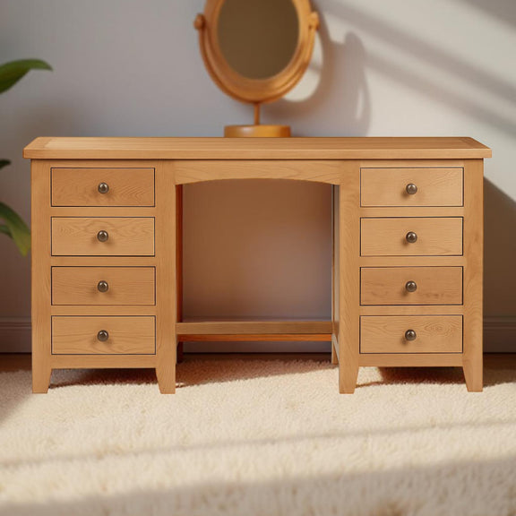 Wooden vanity with multiple drawers and a mirror on a light background
