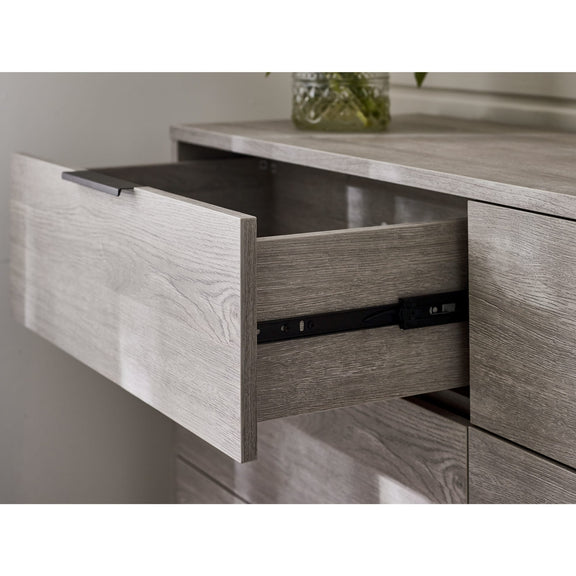 Wooden drawer with a metallic handle on a wooden cabinet.