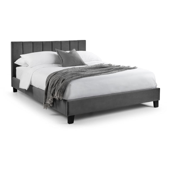 Gray upholstered bed with white bedding and gray blanket on a white background