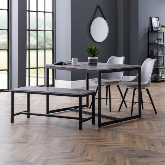 Dining area with a table, chairs, and bench in a modern interior setting.