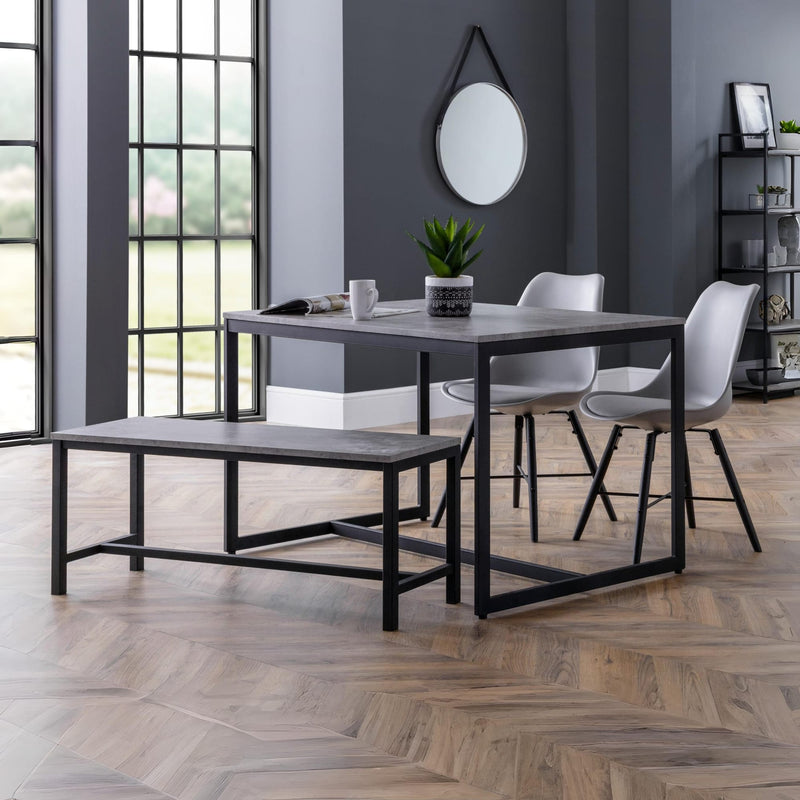 Dining area with a table, chairs, and bench in a modern interior setting.