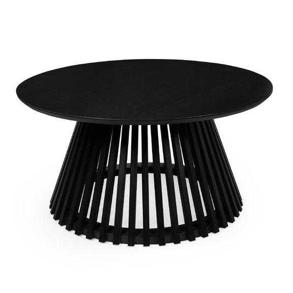 Black round table with unique base design on a white background