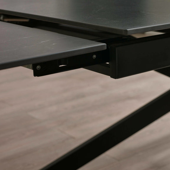 Close-up of a black metal bracket on a wooden surface