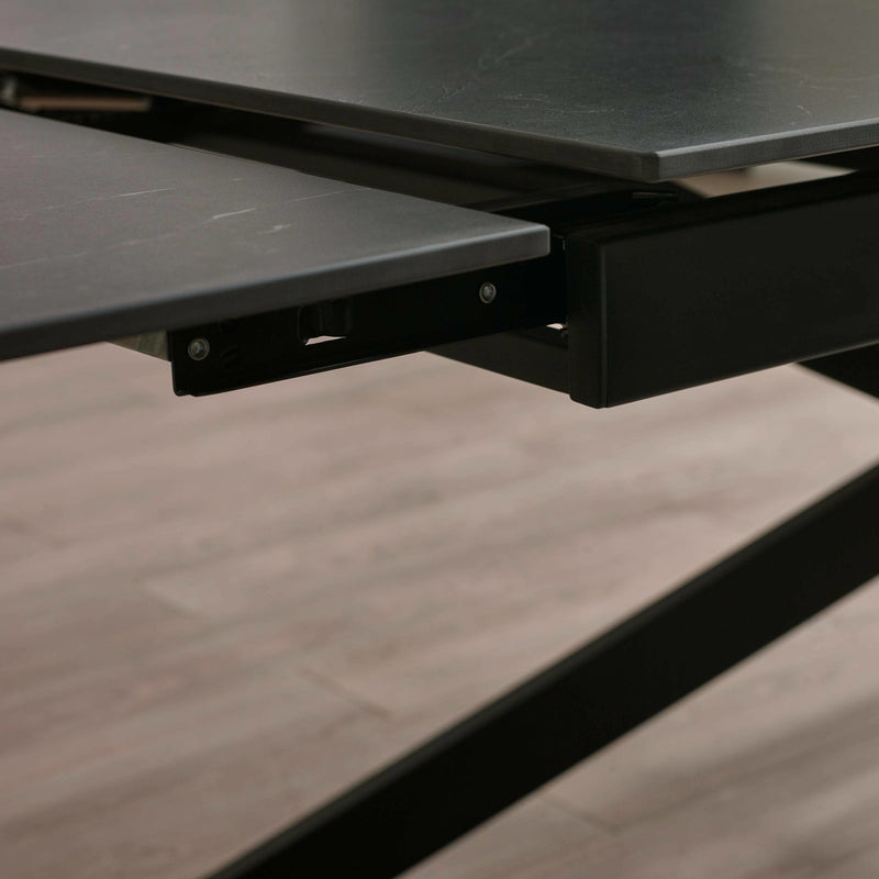 Close-up of a black metal bracket on a wooden surface