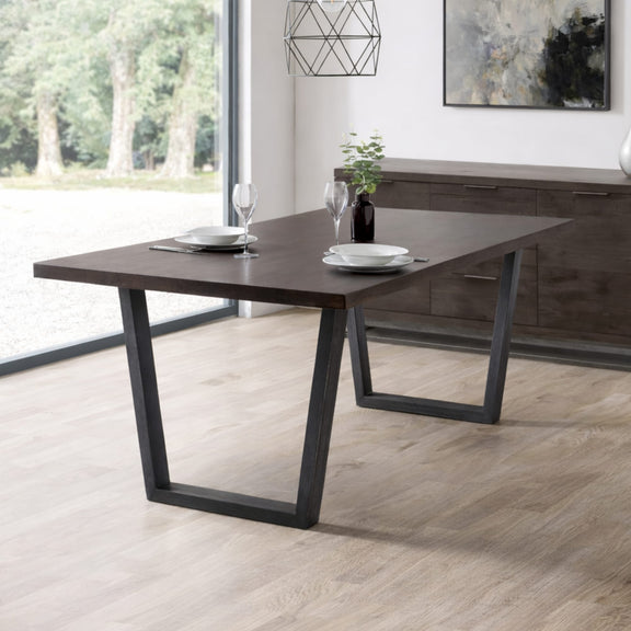 Dining table with black metal legs in a modern room setting