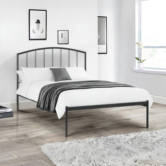 Black metal bed frame with white bedding in a modern bedroom.