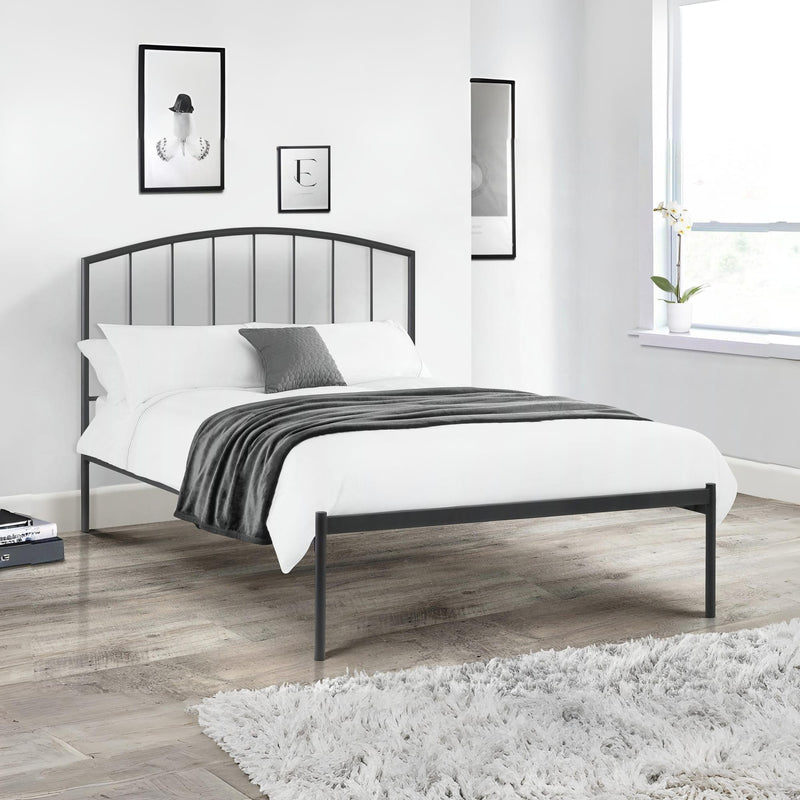 Black metal bed frame with white bedding in a modern bedroom.