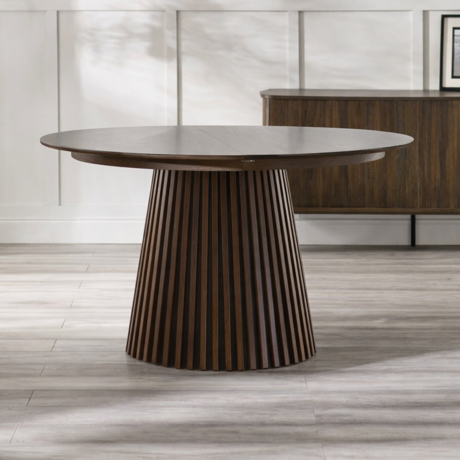 Wooden dining table with a modern design on a wooden floor.