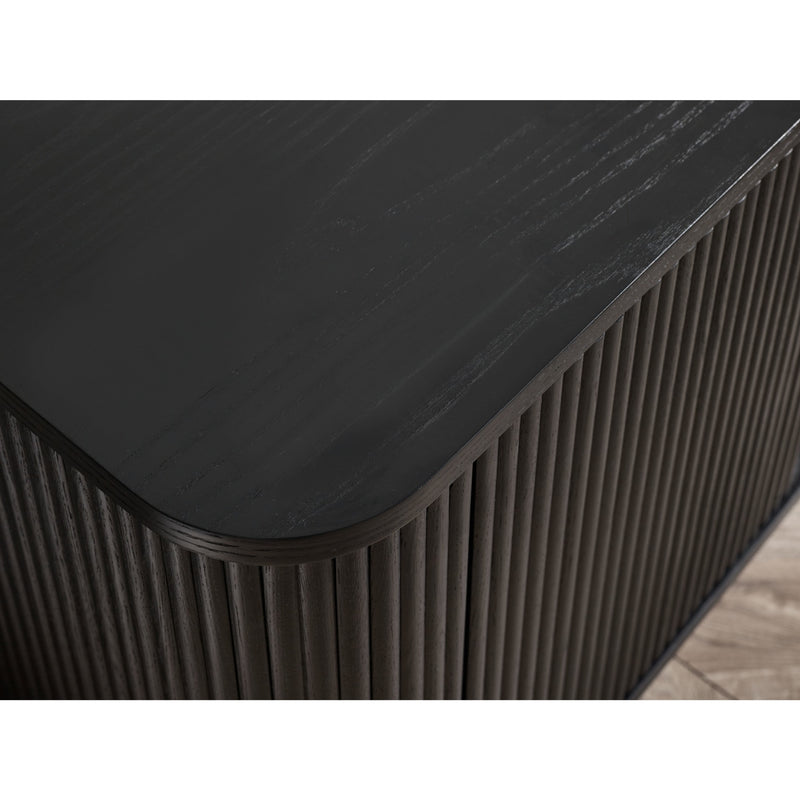 Black rectangular table with ribbed edge on a wooden floor