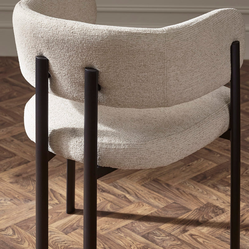 Chair with beige fabric seat and backrest on a wooden floor