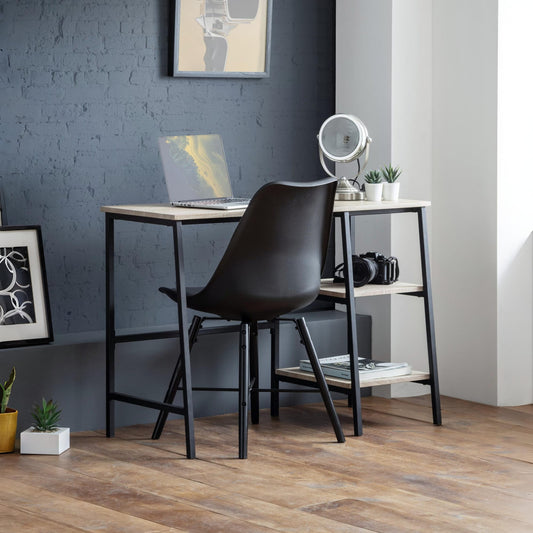 Modern office desk with black chair against a gray wall