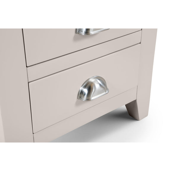 Close-up of a light gray dresser with a silver handle on a white background