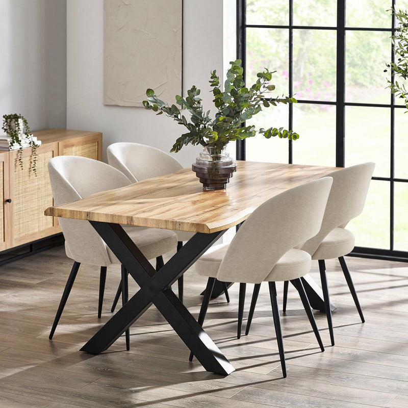 Dining room with a wooden table and white chairs near a large window.