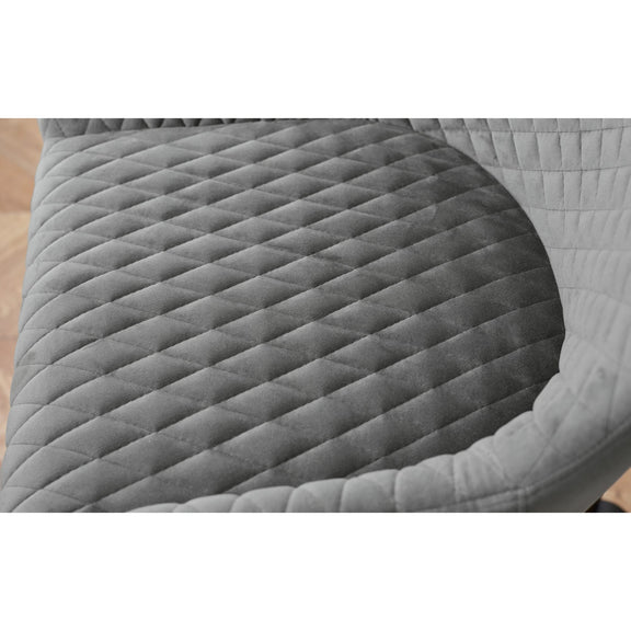 Gray quilted saddle pad on a wooden surface