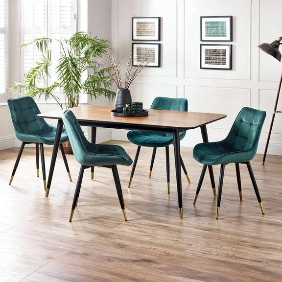 Dining room with a wooden table and teal chairs on a wooden floor.