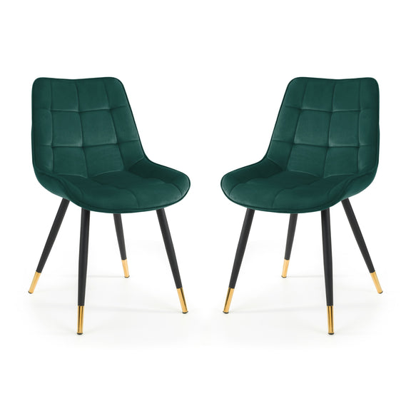 Two green chairs with black legs and gold tips on a white background
