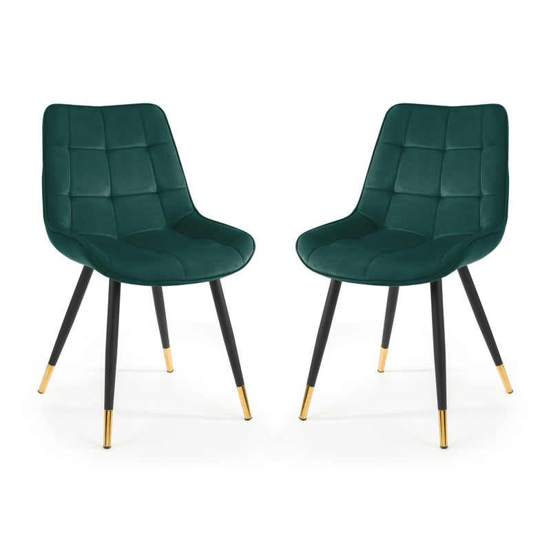 Two green chairs with black legs and gold tips on a white background