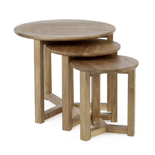 Set of three wooden nesting tables on a white background