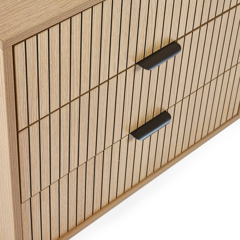 Wooden cabinet with vertical slats and black handles on a white background
