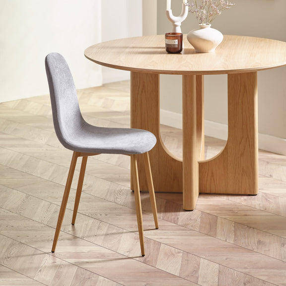 Wooden dining table with a gray chair on a wooden floor