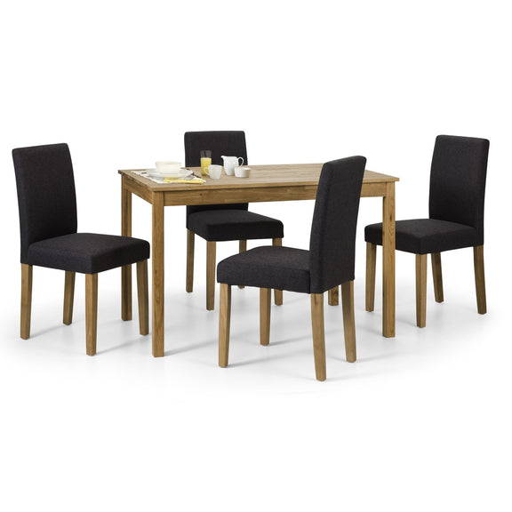 Dining table set with four black chairs on a white background