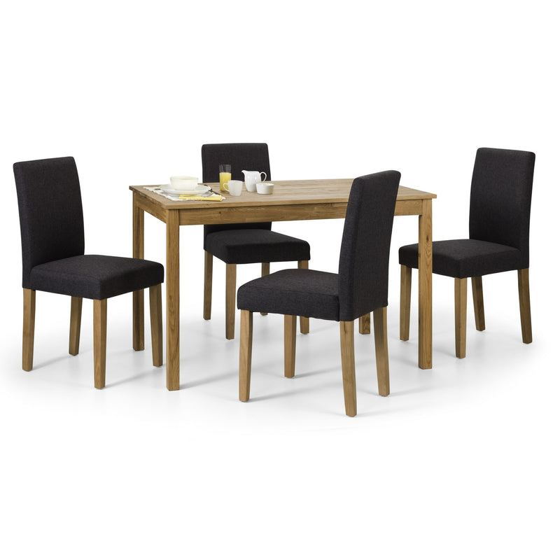 Dining table set with four black chairs on a white background