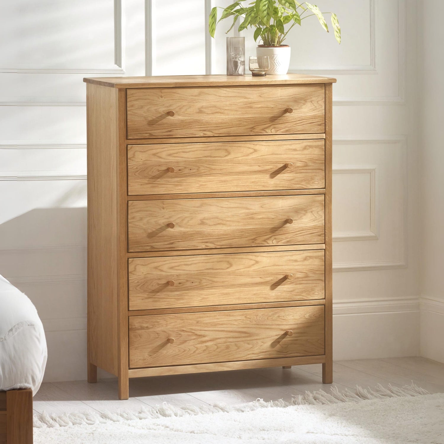 Wooden dresser with four drawers in a room setting
