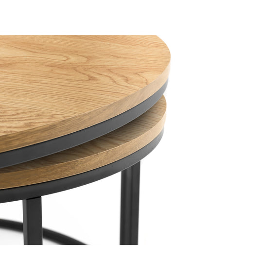 Stack of round wooden tables with black metal legs on a white background