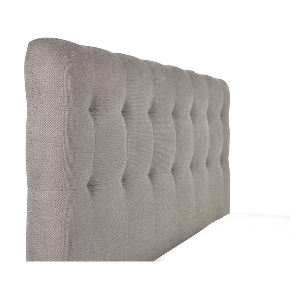 Gray tufted headboard on a white background