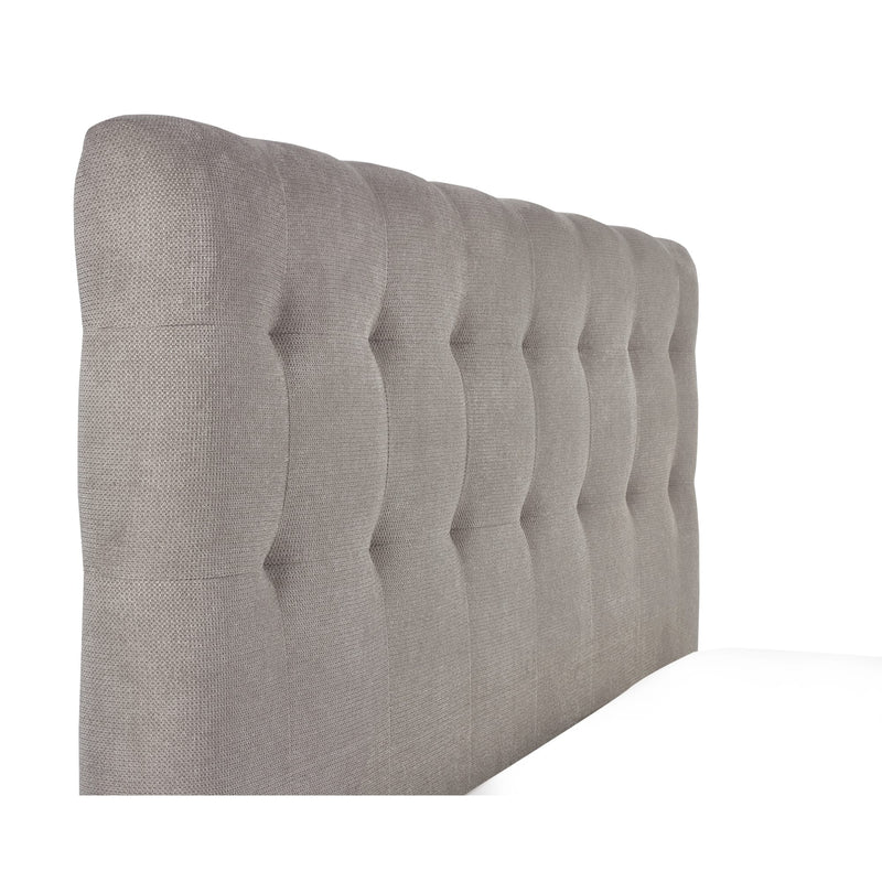 Gray tufted headboard on a white background