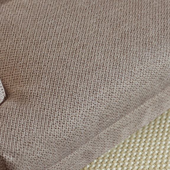 Close-up of textured brown fabric with a subtle pattern