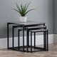Set of three nesting tables with a plant on top against a gray wall.
