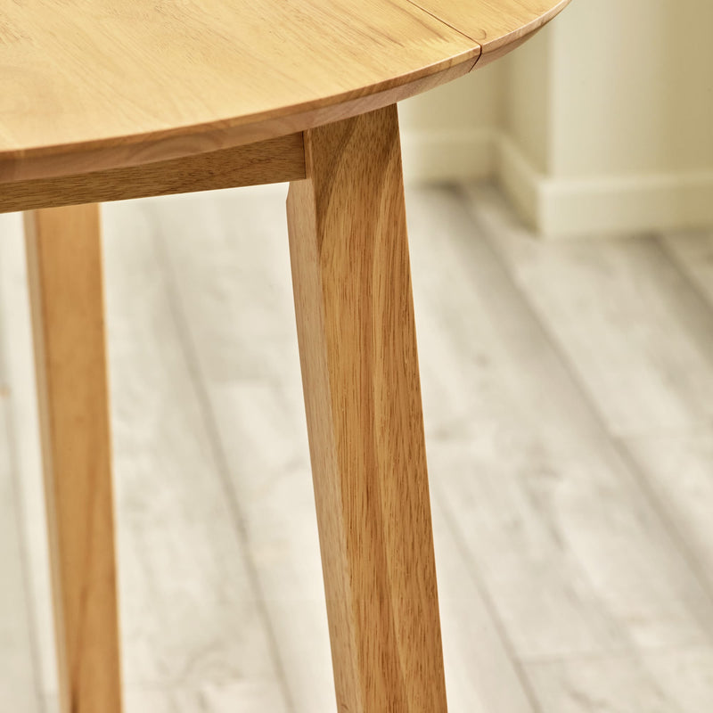 Close-up of a wooden table leg on a light background