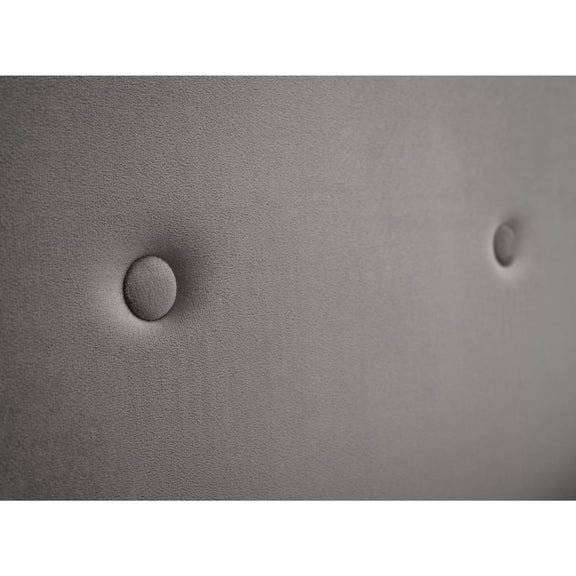 Close-up of a textured gray surface with two circular indentations.