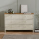 Beige dresser with wooden top in a room setting