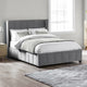 Gray upholstered bed with white bedding in a bedroom setting