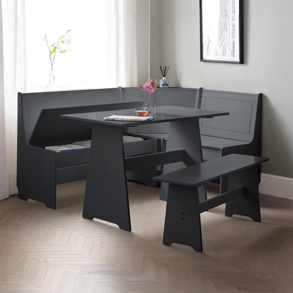 Black dining set with bench seating in a room with light-colored walls and wooden floor.