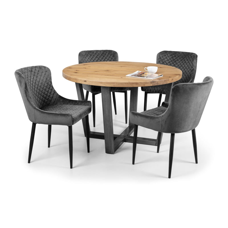 Round wooden table with four gray chairs on a white background